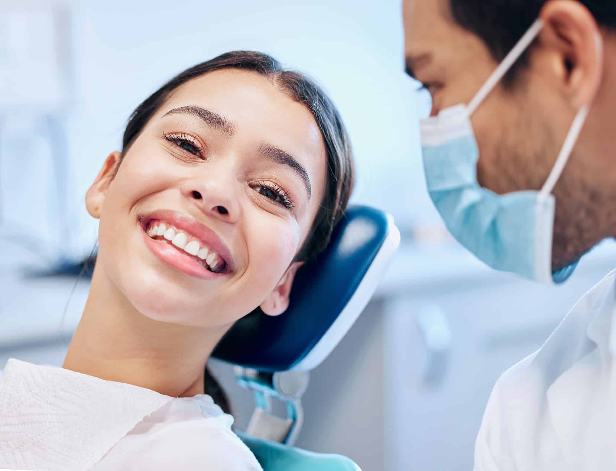 woman smiling at dental appointment - Twin Oaks Dentistry