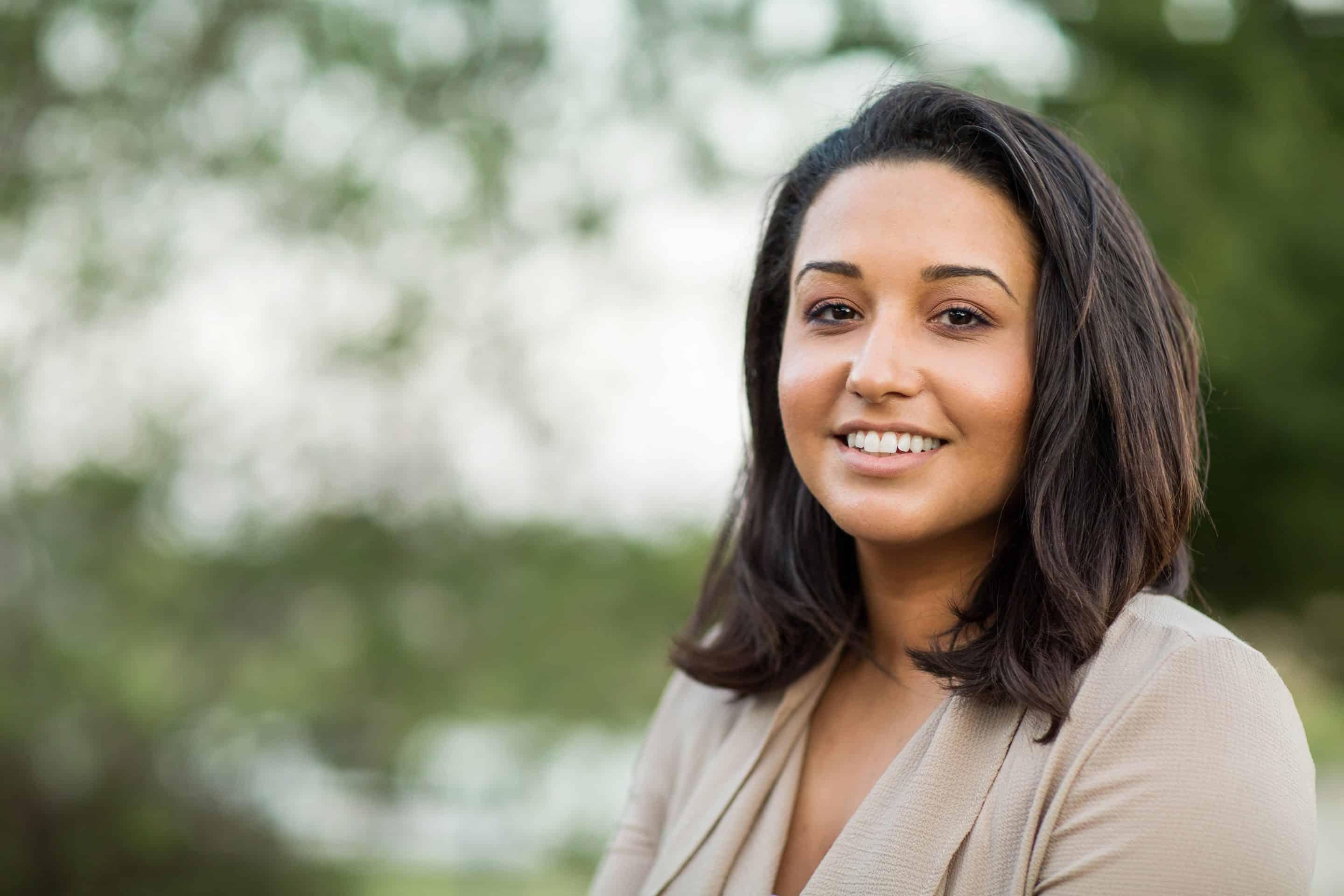 woman smiling outside of Twin Oaks Dentistry