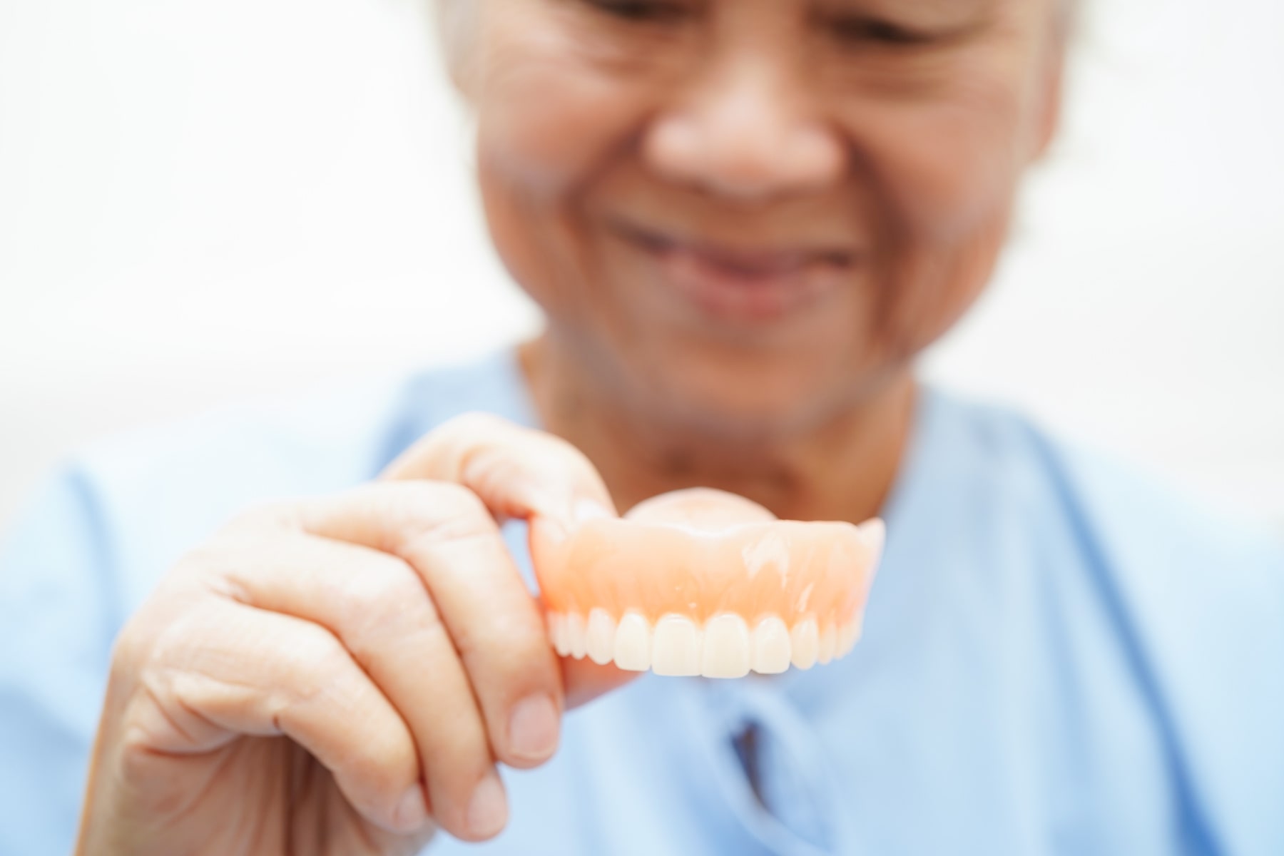DenturesCare_AdobeStock_705644257_1800x1200-min patient satisfied with their dentures and the helpful info from Twin Oaks Dentistry in Winston-Salem NC